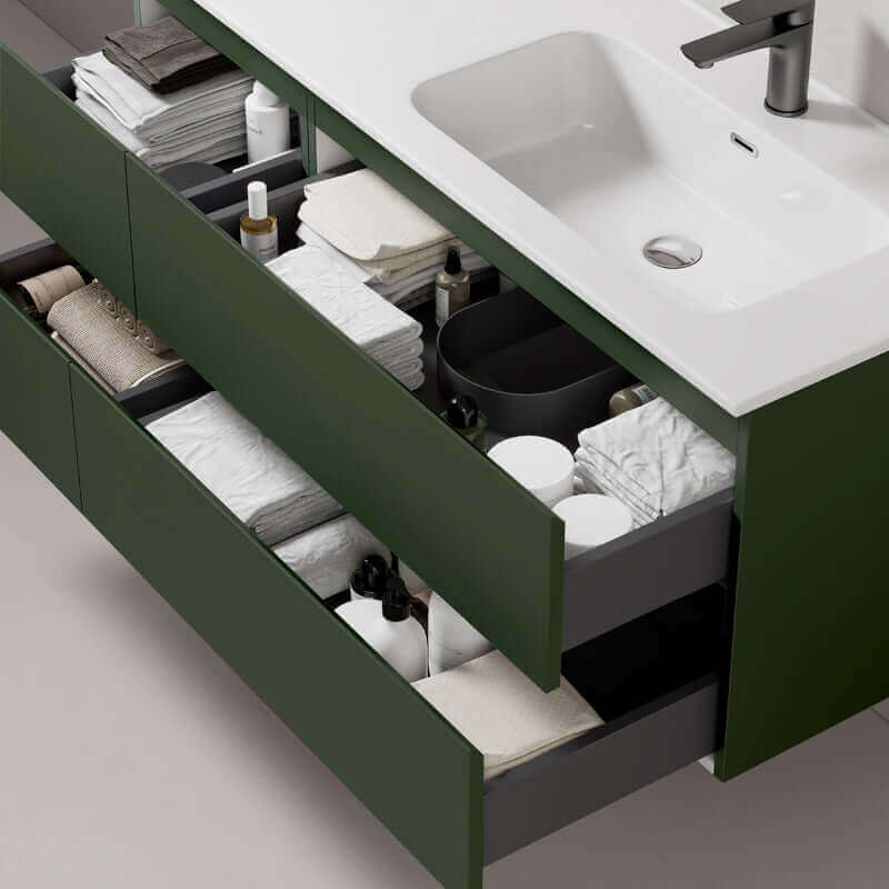 Mobile bagno sospeso verde comodoro con cassetti aperti pieni di prodotti per la cura personale e asciugamani. (25686892)
