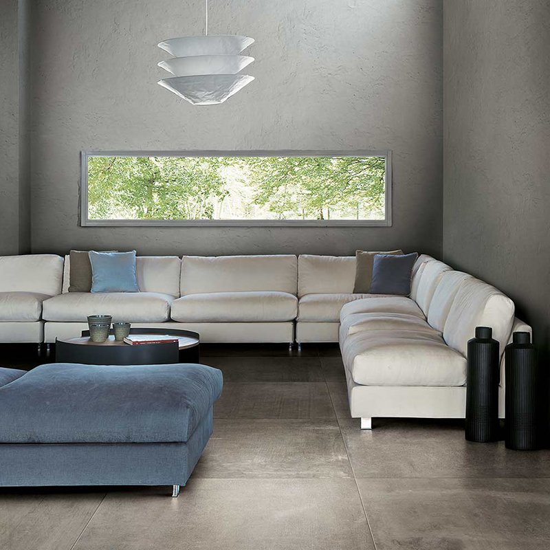 Modern living room featuring Gres Porcellanato Effetto Cemento floor in 80x80 size, with stylish furniture and large window.