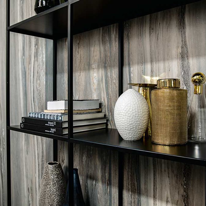 Interior decor featuring Gres Porcellanato Effetto Marmo in a stylish shelf arrangement with decorative vases and books.