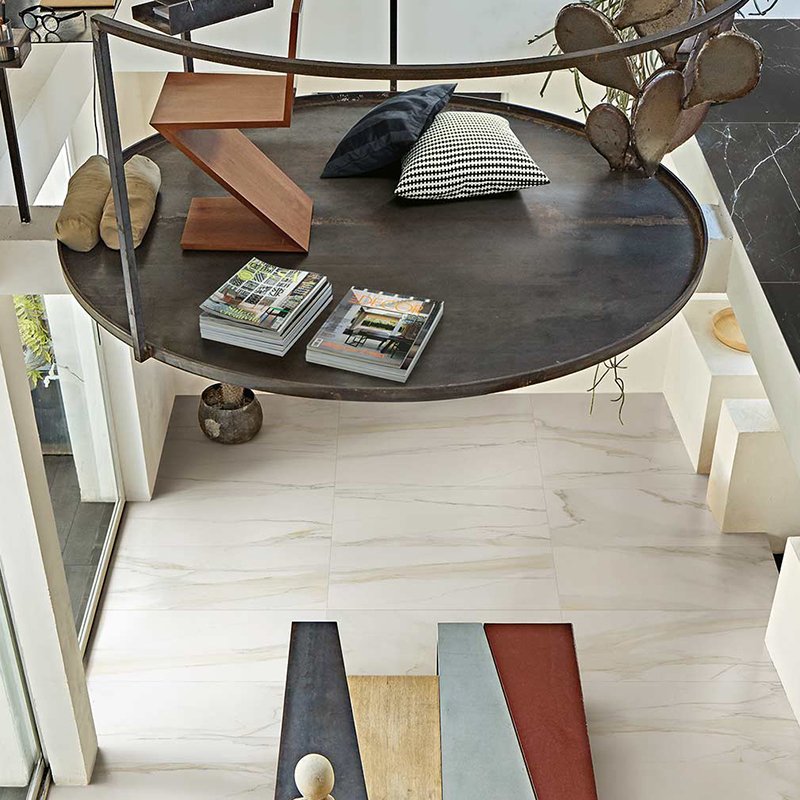 Stylish interior with Calacatta gold porcelain tiles and modern decor by Florim, showcasing a contemporary living space.