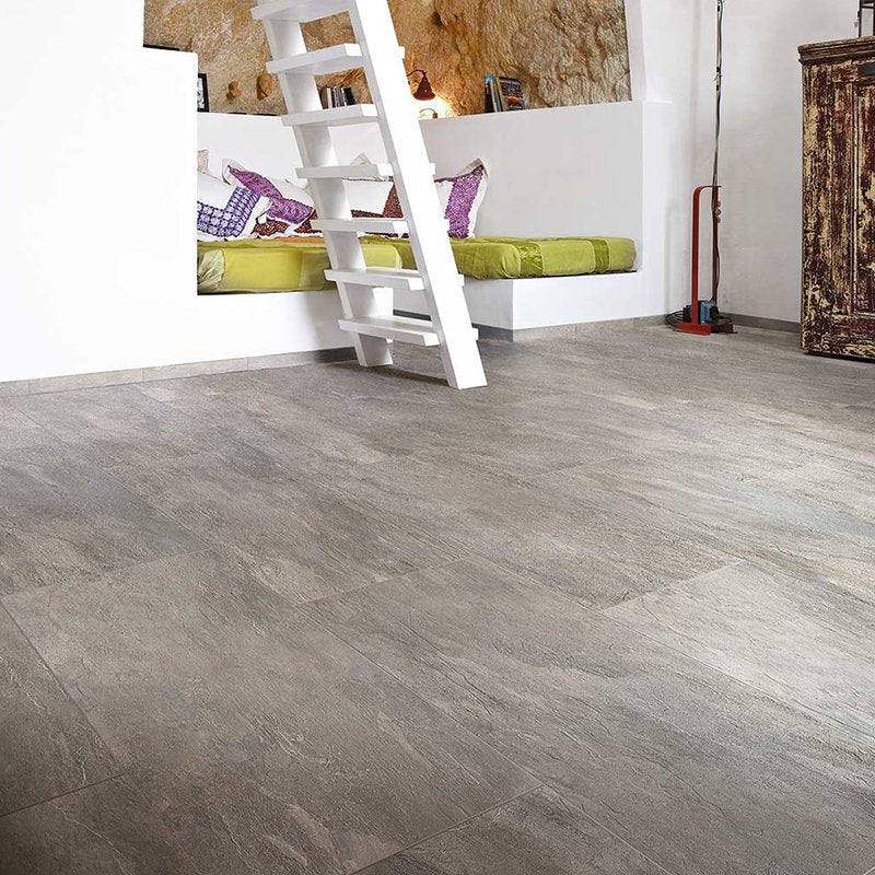 Interior view of a room featuring Florim Gres Porcellanato Effetto Pietra Rettificato Grip Plombe Ardoise flooring.