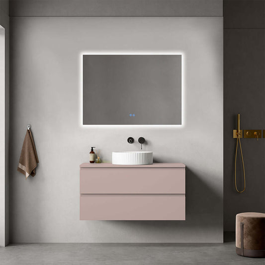Mobile bagno sospeso rosa retrò da 100 cm con lavabo d'appoggio e specchio retroilluminato in un bagno moderno.