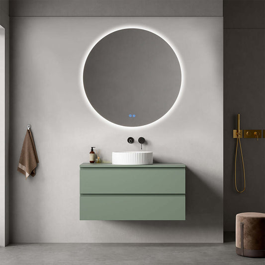 Mobile bagno sospeso verde salvia con lavabo circolare e specchio retroilluminato in un moderno bagno.