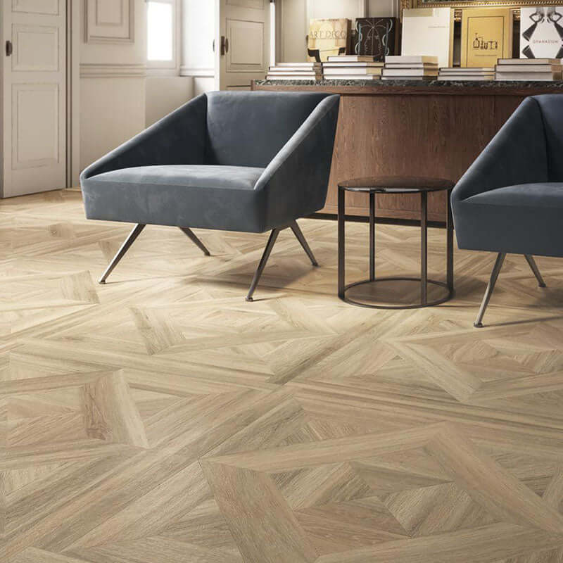 Interior view with Gres Porcellanato Effetto Legno flooring, featuring gray chairs and wooden furniture.
