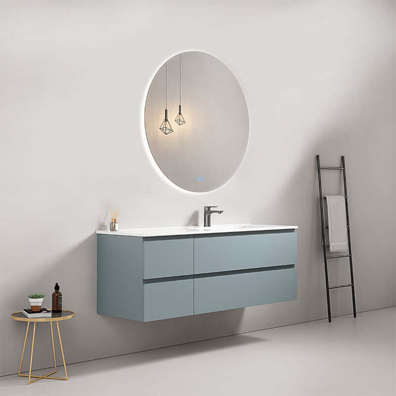Mobile bagno sospeso Blu Avio con lavabo e specchio tondo retroilluminato in un design moderno.