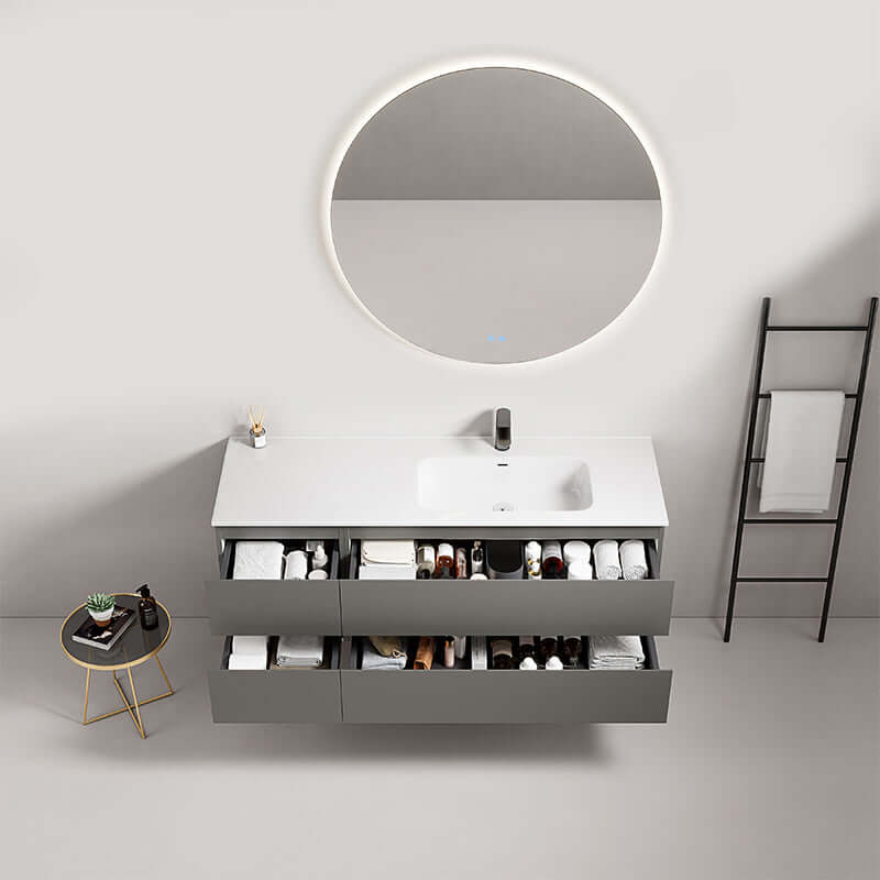 Mobile bagno sospeso grigio Londra con lavabo a destra e specchio tondo retroilluminato in ambiente moderno.