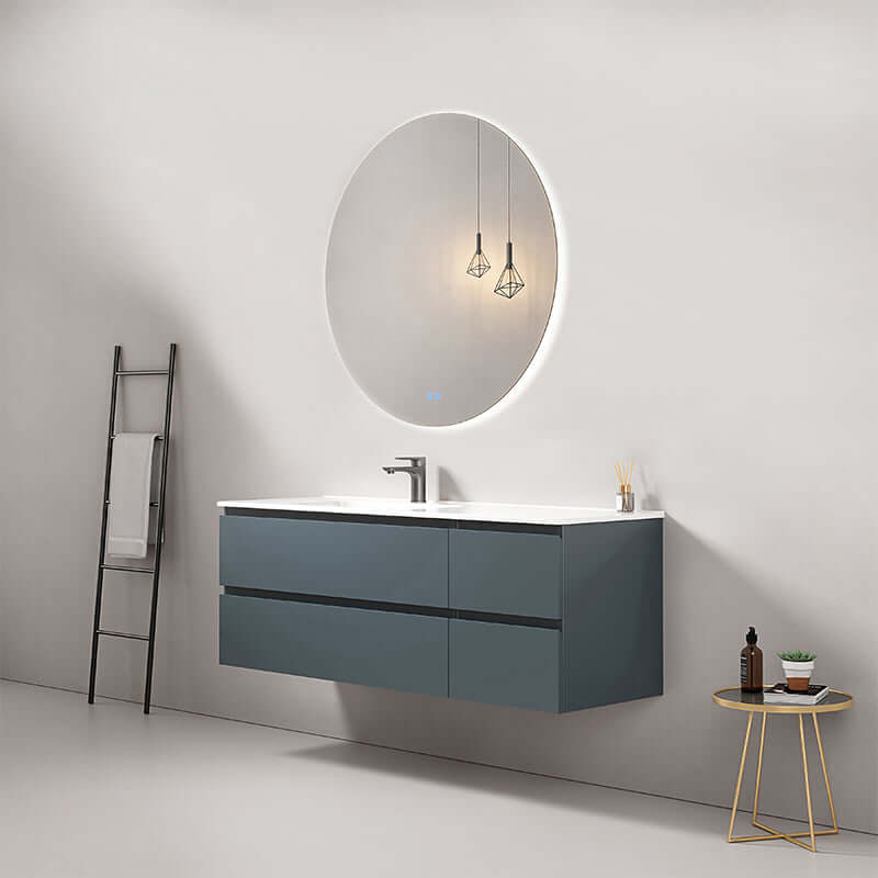 Mobile bagno sospeso Fiji 140 cm blu mare con lavabo a sinistra e specchio tondo retroilluminato.