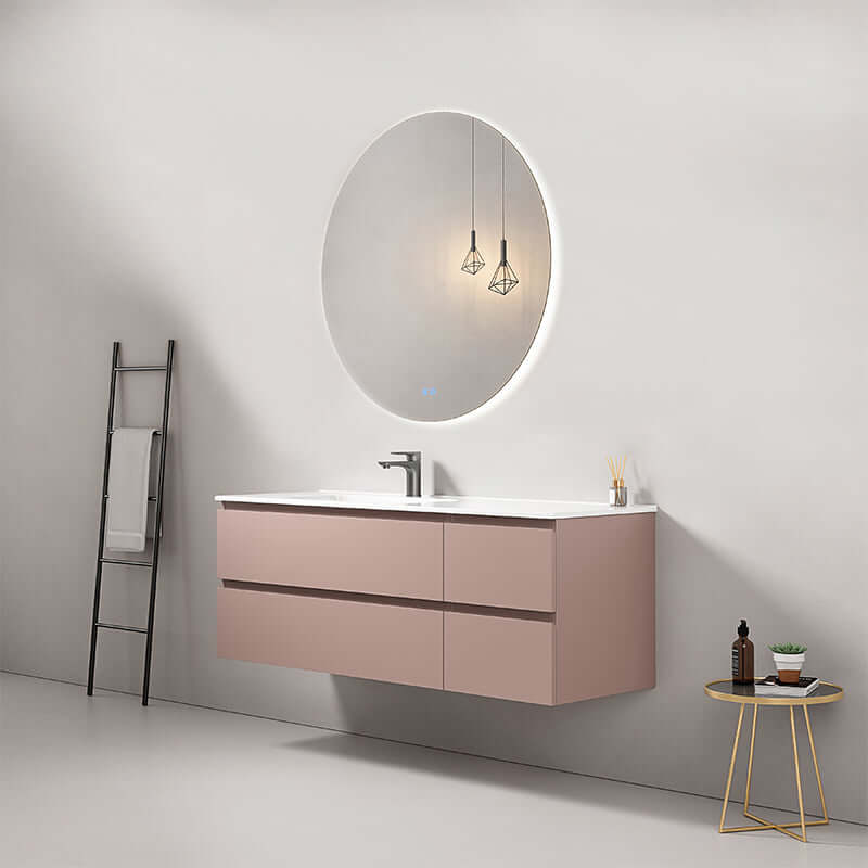 Mobile bagno sospeso 140 cm rosa retro con lavabo a sinistra e specchio tondo retroilluminato in design moderno.