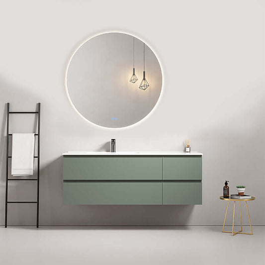 Mobile bagno sospeso verde salvia con lavabo a sinistra e specchio tondo retroilluminato in ambiente moderno.