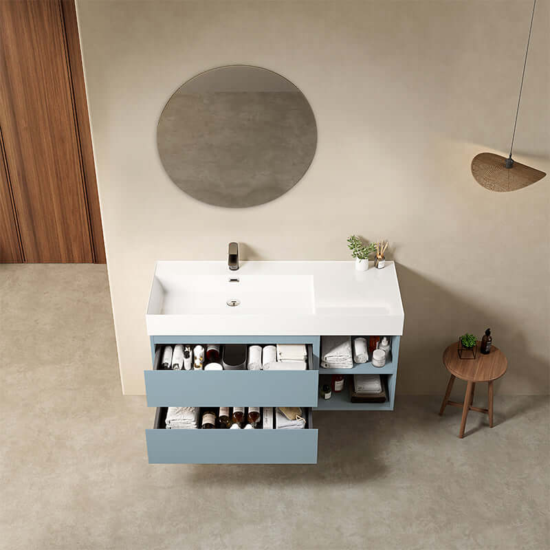 Mobile bagno sospeso Blu Avio con lavabo a sinistra e specchio tondo retroilluminato, design moderno e funzionale.