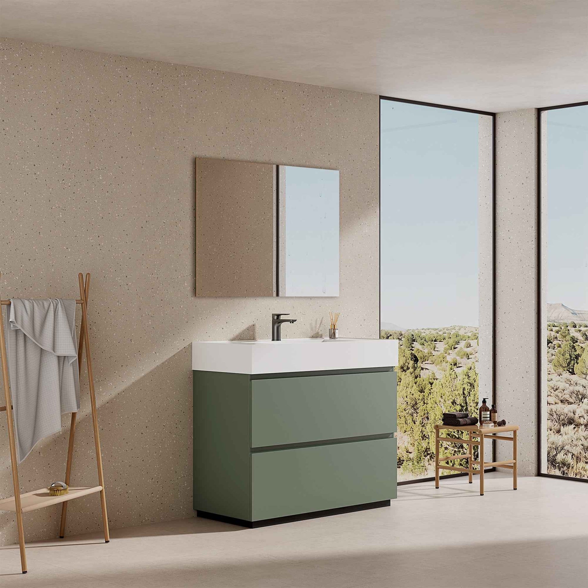 Mobile bagno a terra verde salvia con lavabo in resina e specchio tondo retroilluminato