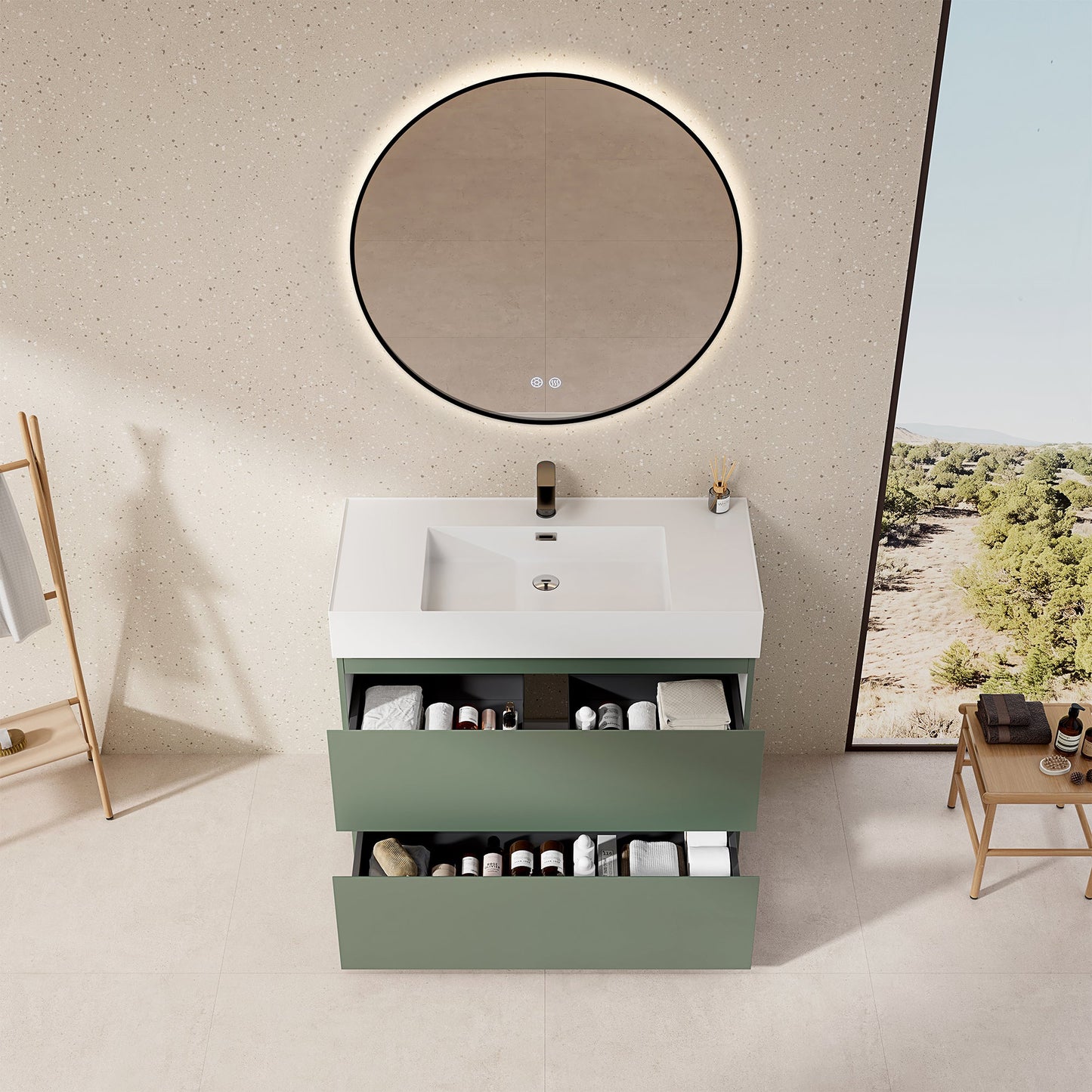 Mobile bagno a terra verde salvia con lavabo in resina e specchio tondo retroilluminato.