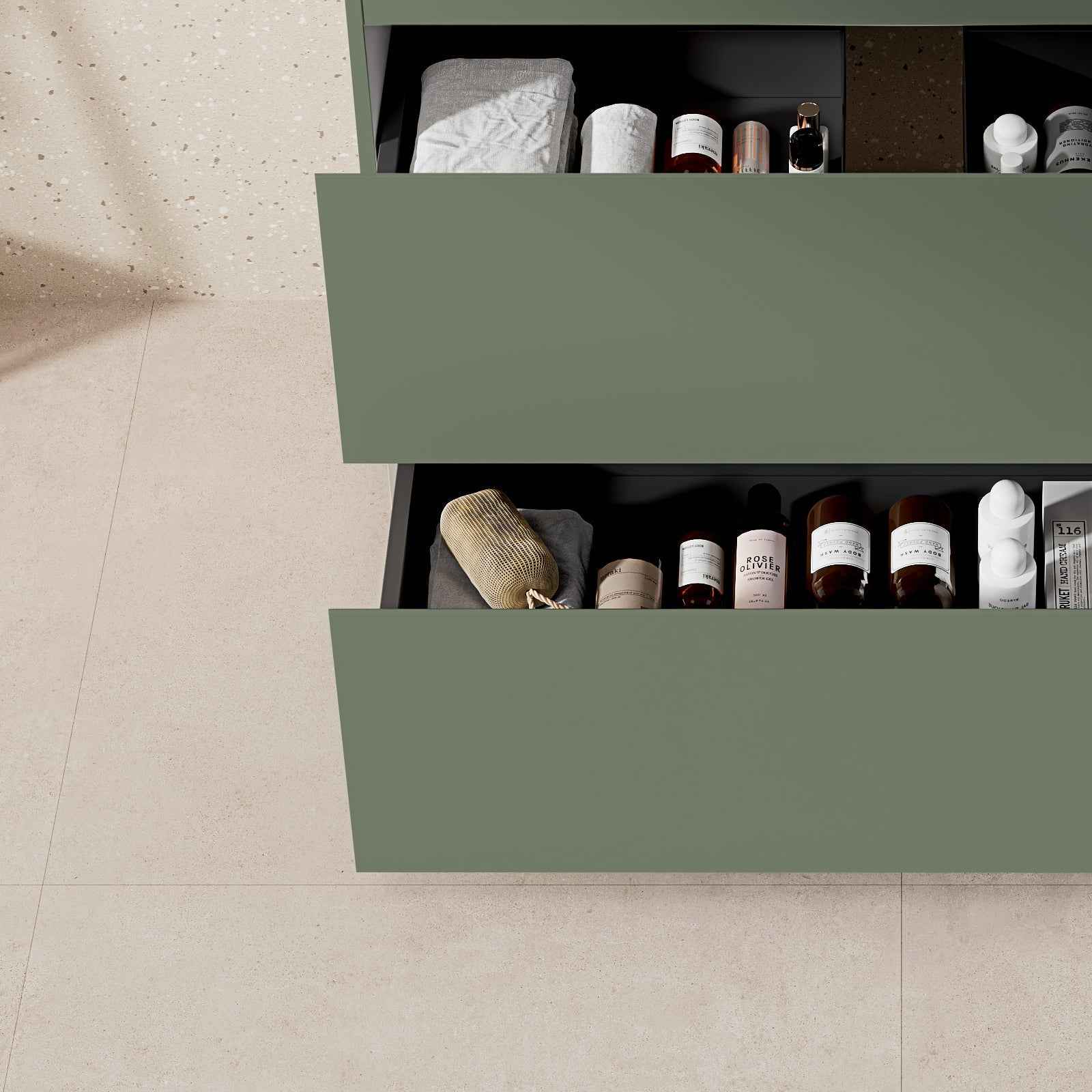 mobile bagno a terra verde salvia con cassetti aperti mostrando prodotti e asciugamani all'interno.