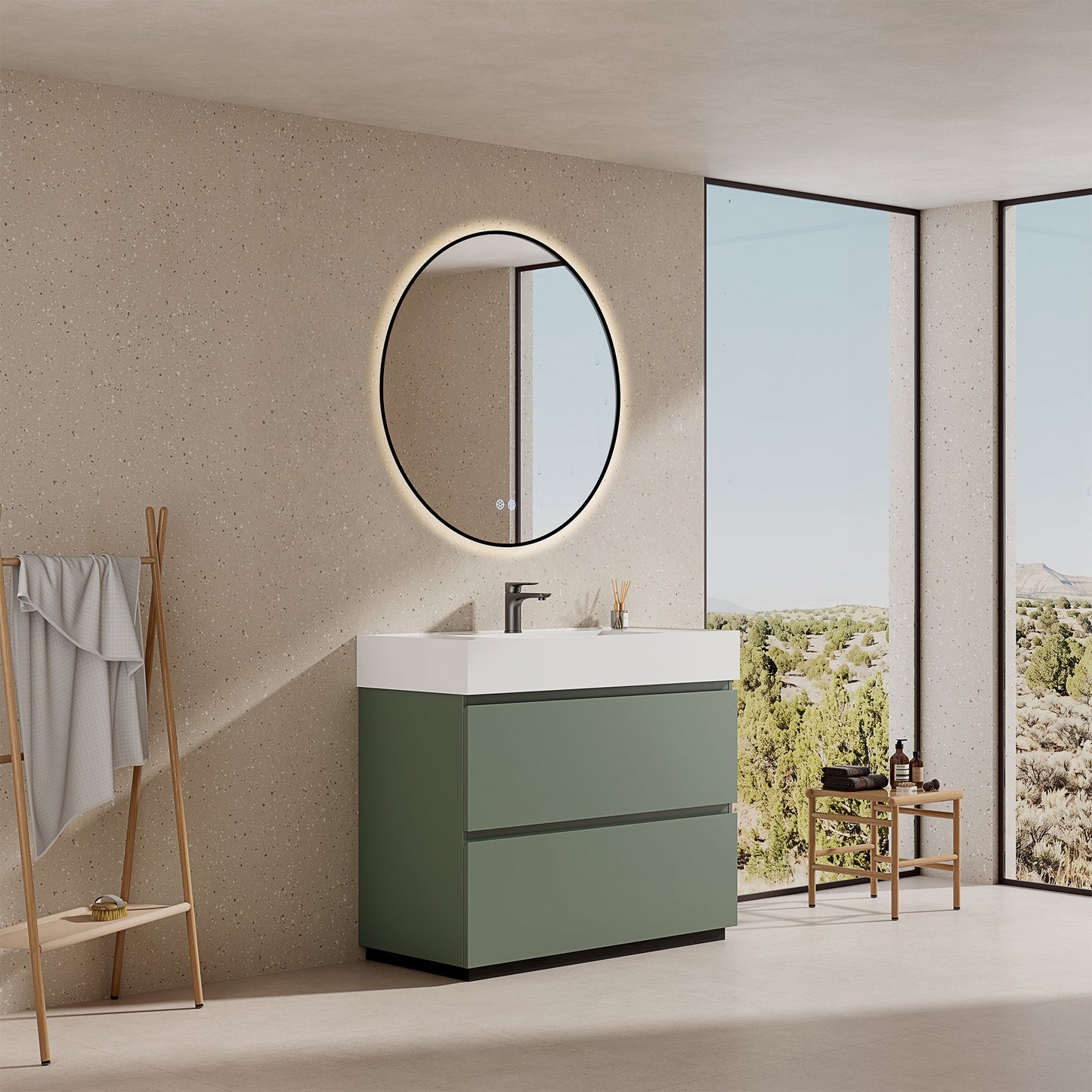 Mobile bagno a terra verde salvia con lavabo in resina e specchio tondo retroilluminato nella stanza.