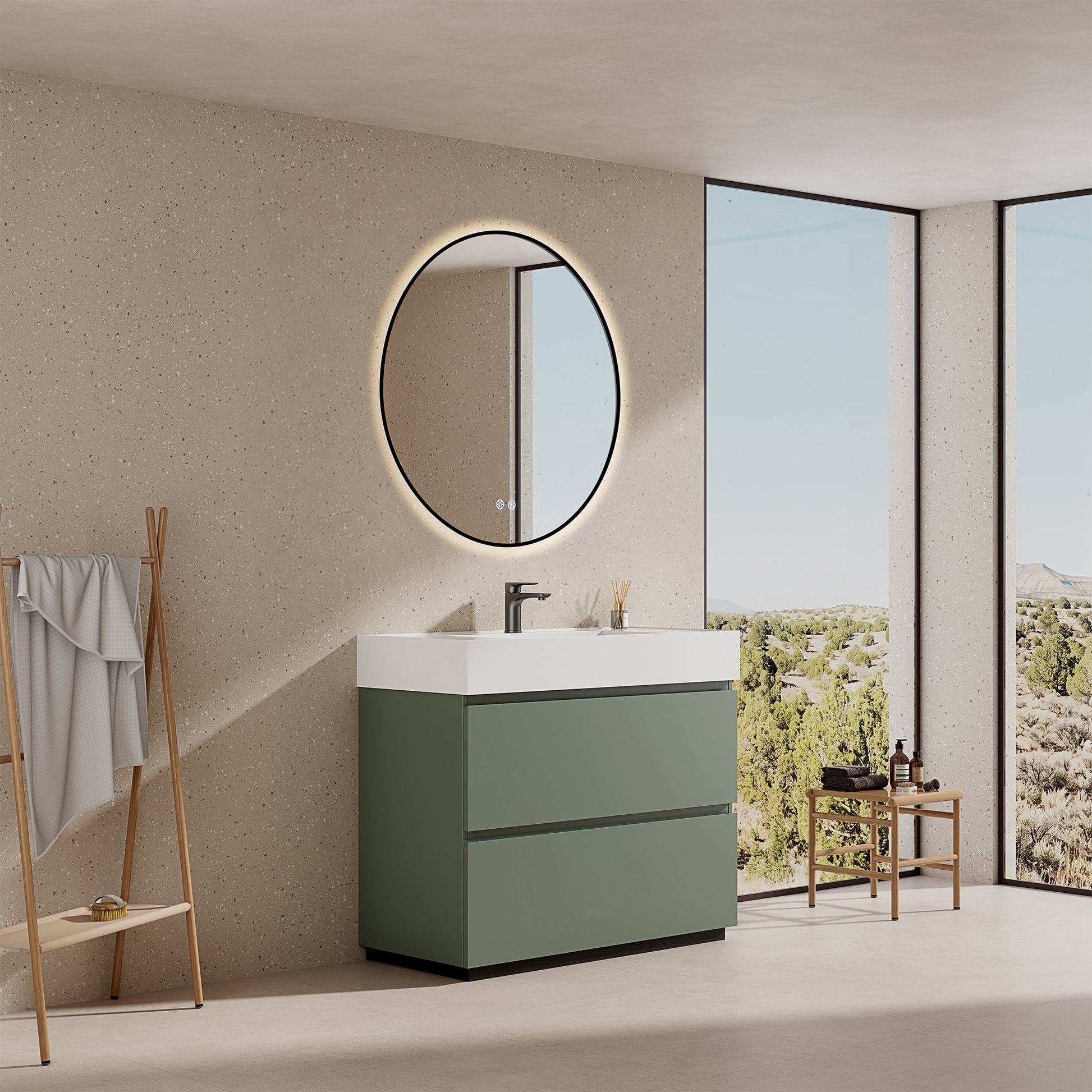 Mobile bagno a terra verde salvia con lavabo in resina e specchio tondo retroilluminato nella stanza.