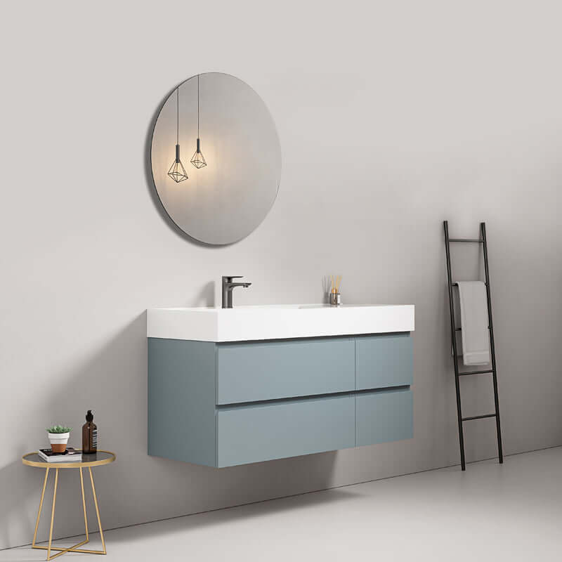 Mobile bagno sospeso Blu Avio con lavabo a sinistra, specchio tondo e arredamento moderno.