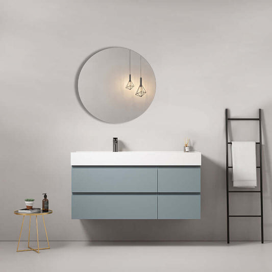 Mobile bagno sospeso Blu Avio con lavabo in resina e specchio tondo in un ambiente moderno e minimalista.